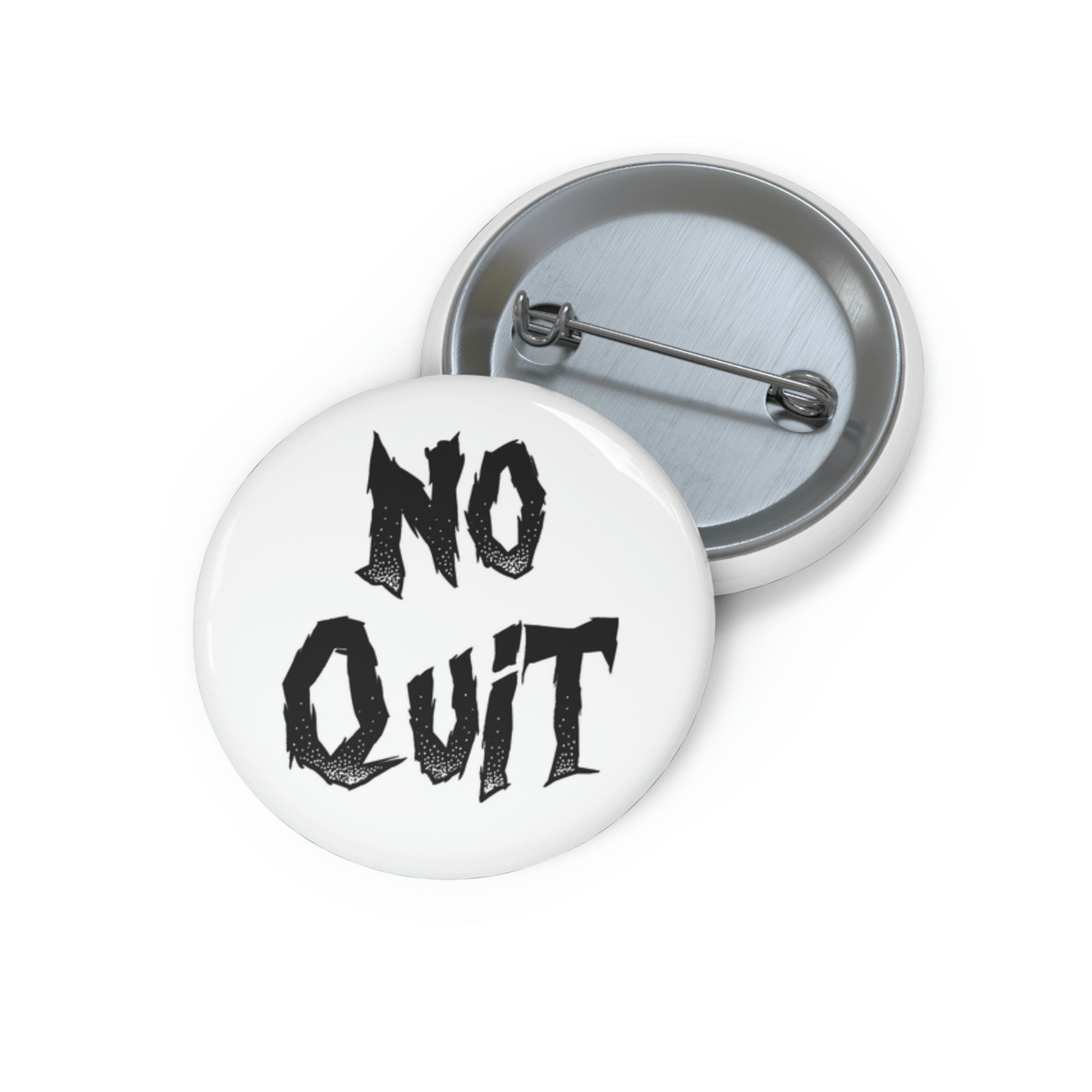 A pin button with a white background featuring the text 'NO QUIT' in black, with a metal rim and a safety pin backing.